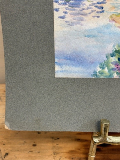 Gray textured paper with a watercolor floral design on a wooden surface