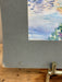 Gray textured paper with a watercolor floral design on a wooden surface