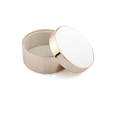 Round white enamel container with a white lid on a white background