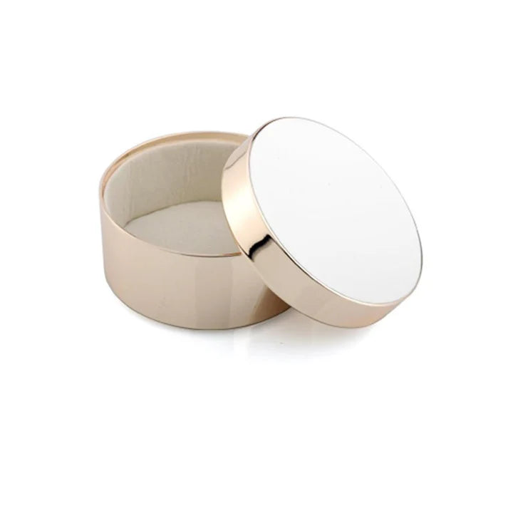 Round white enamel container with a white lid on a white background