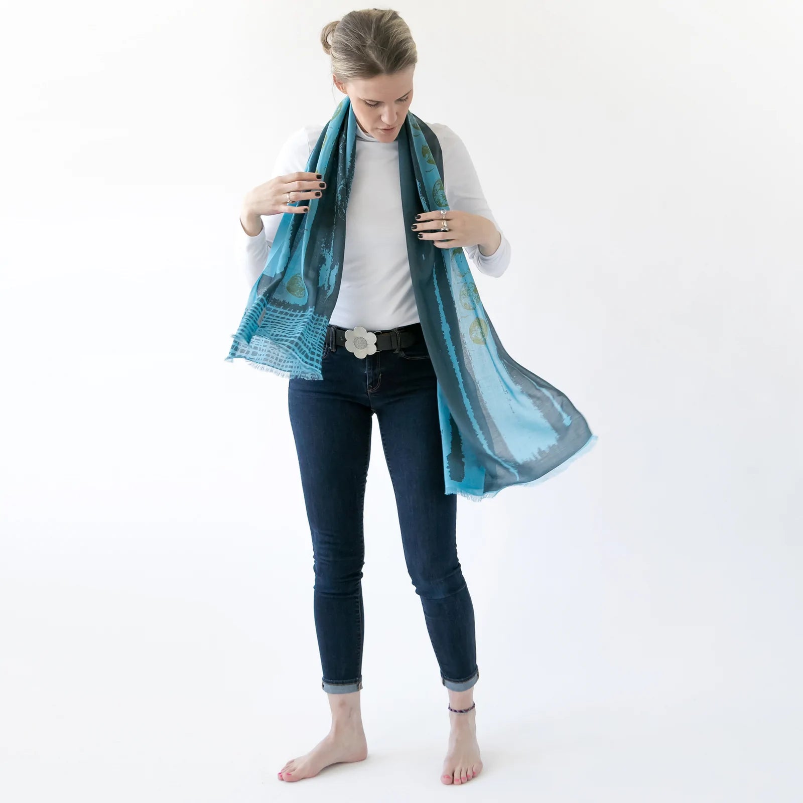woman modeling a 100% merino wool scarf in blue