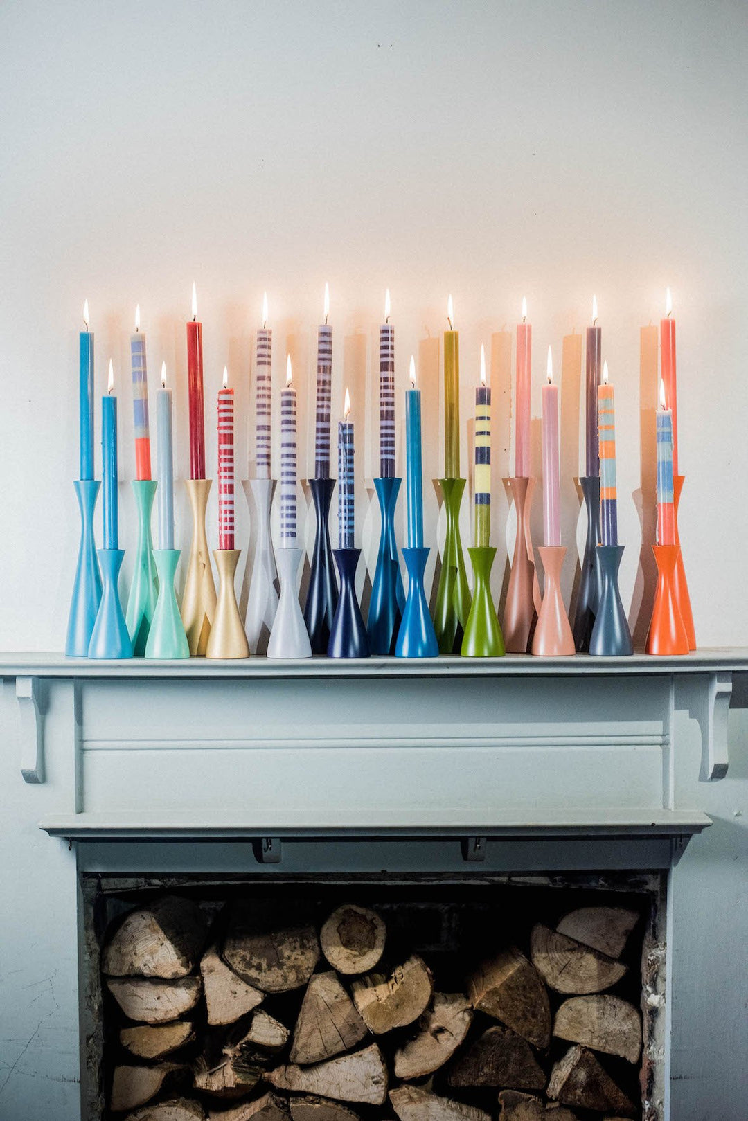 collection of striped candles and wood holders