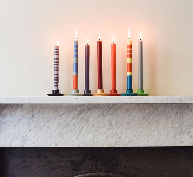 striped and solid dinner candles on fireplace mantel