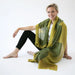 woman modeling light green and dark green merino wool scarf