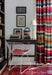 desk with vintage typewriter and modern chair, striped drapery, oriental rug