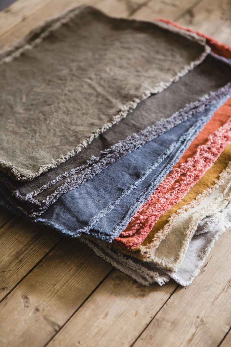 stack of frayed-edge linen placemats from Libeco