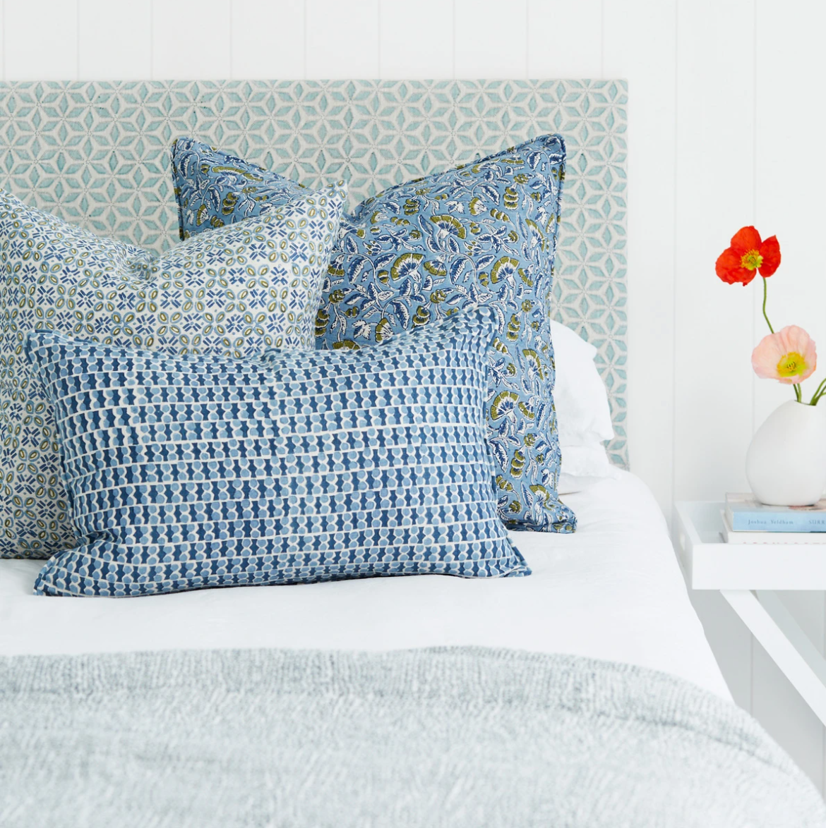 blue and green mix of pillows on bed