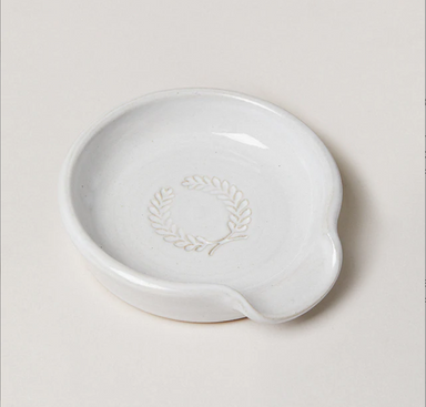 white pottery spoon rest