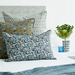 blue and tobacco patterned pillows on bed
