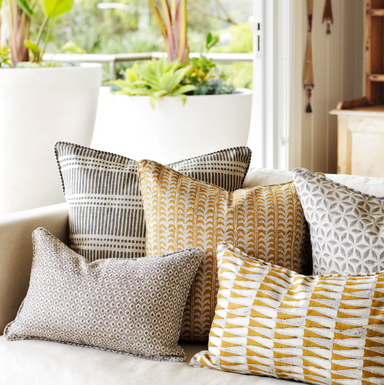 collection of block print pillows on sofa