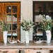 a rustic table set with horn vases filled with wildflowers and antlers