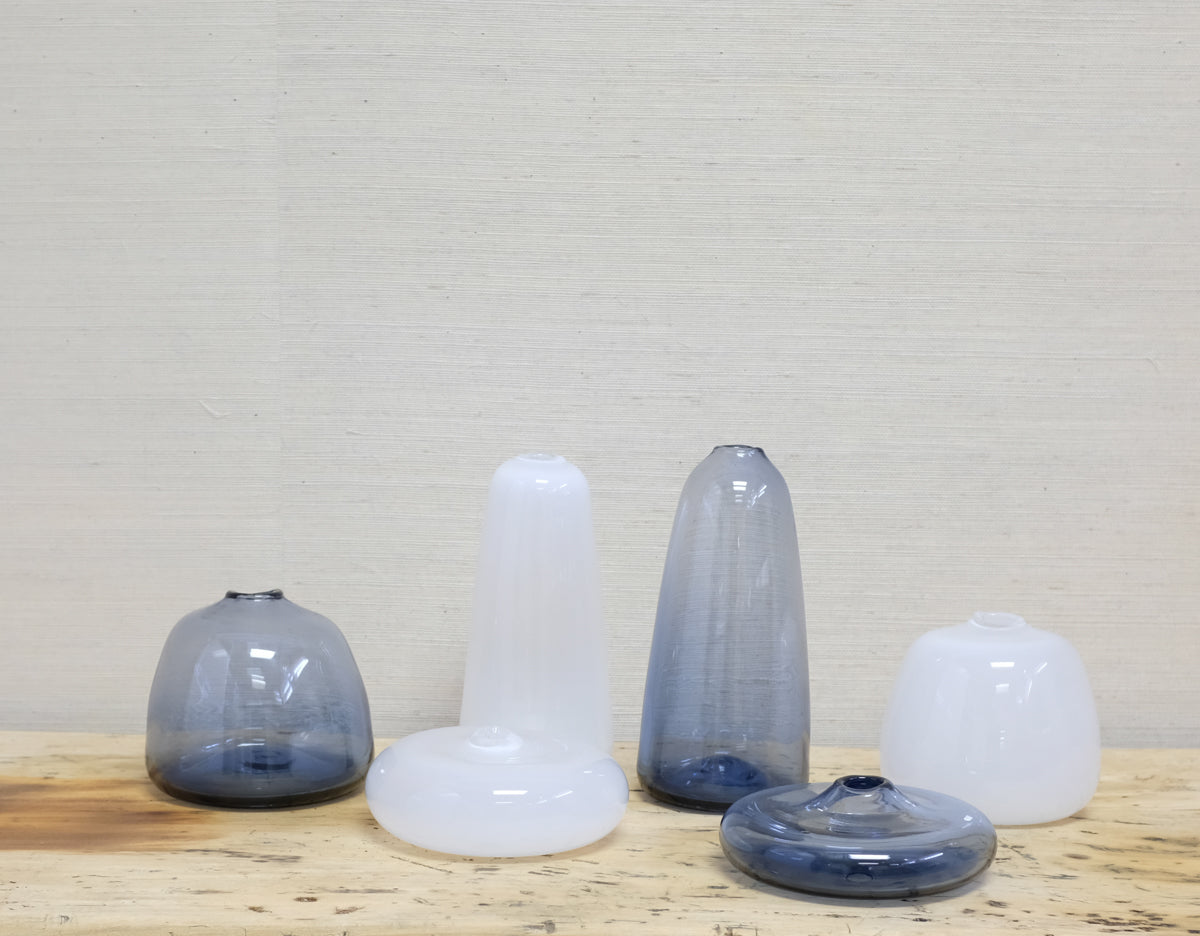 collection of white and blue glass vases in various shapes