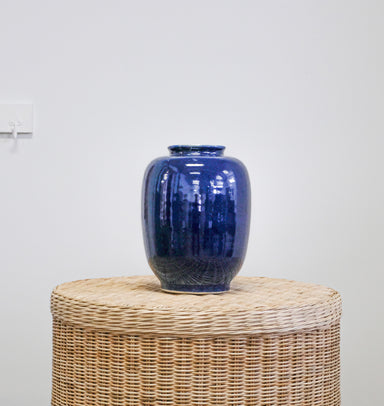 blue ceramic jar on wicker table