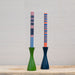 striped candles in green and blue wood candleholders