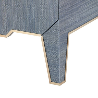 brass-edged leg detail on blue chest of drawers