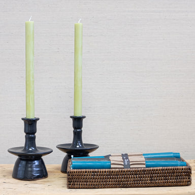 celadon color tapers in black pottery candleholders