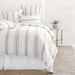 grey and white striped linen duvet cover and shams on bed with white linen bedskirt
