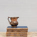 lusterware pitcher on stack of books