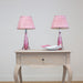 pair of pink val st lambert lamps on side table