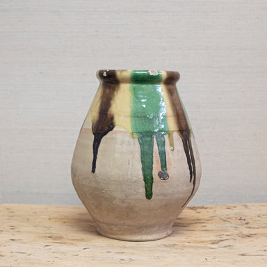 terra cotta pot with dripping glaze in green, yellow and brown