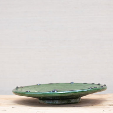 side view of green moroccan pottery plate