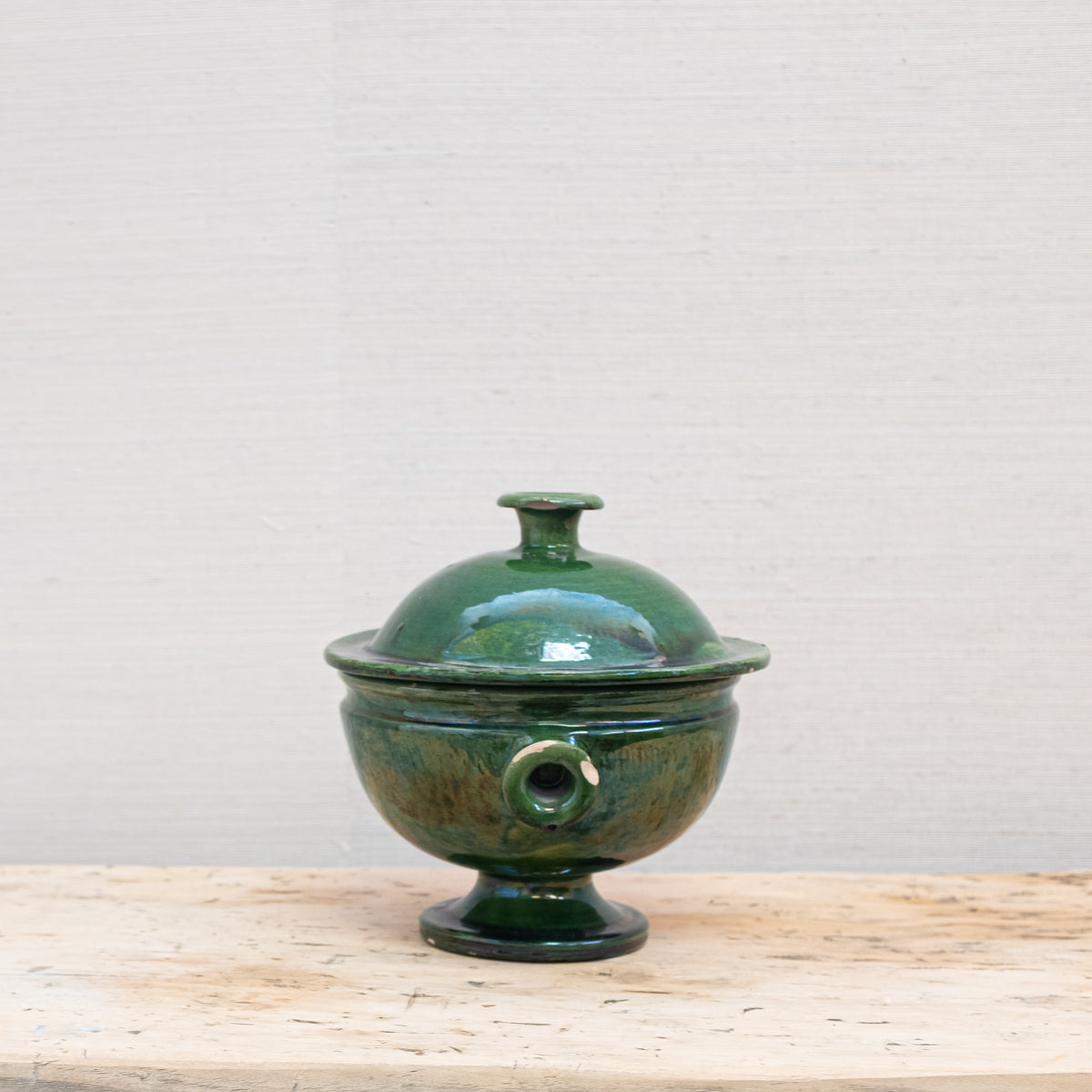 side view of green lidded pottery