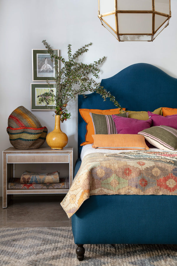 blue upholstered bed and multiple textiles