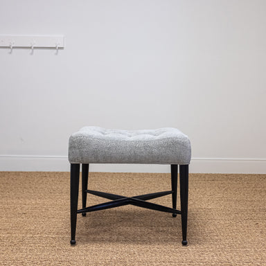 black legged upholstered tufted stool