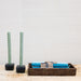 sage green twist taper candles in black forged iron holder