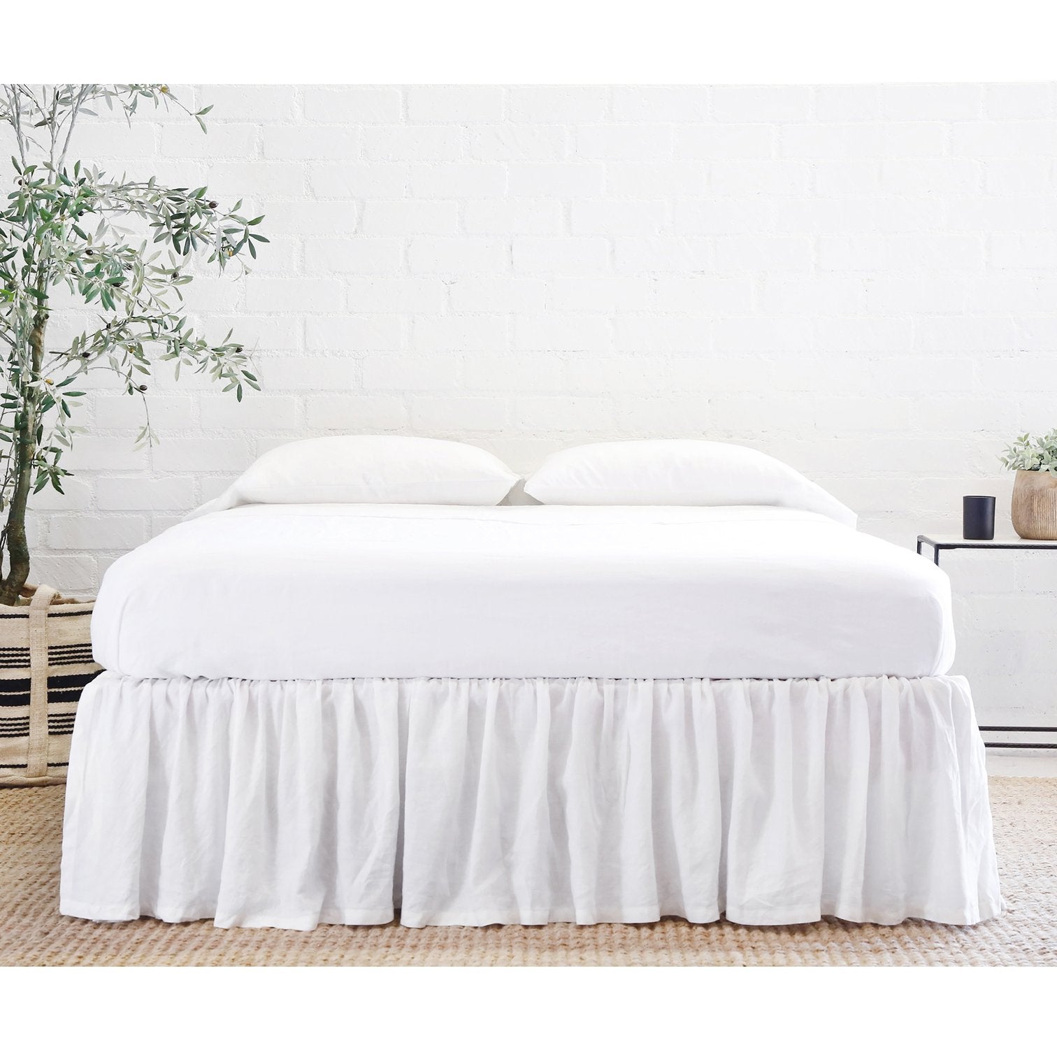 bed shown with white linen gathered bedskirt